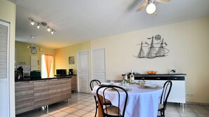 A modern kitchen with a dining area.