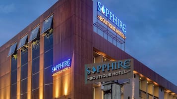 A modern hotel with a prominent 'Sapphire Boutique Hotel' sign.