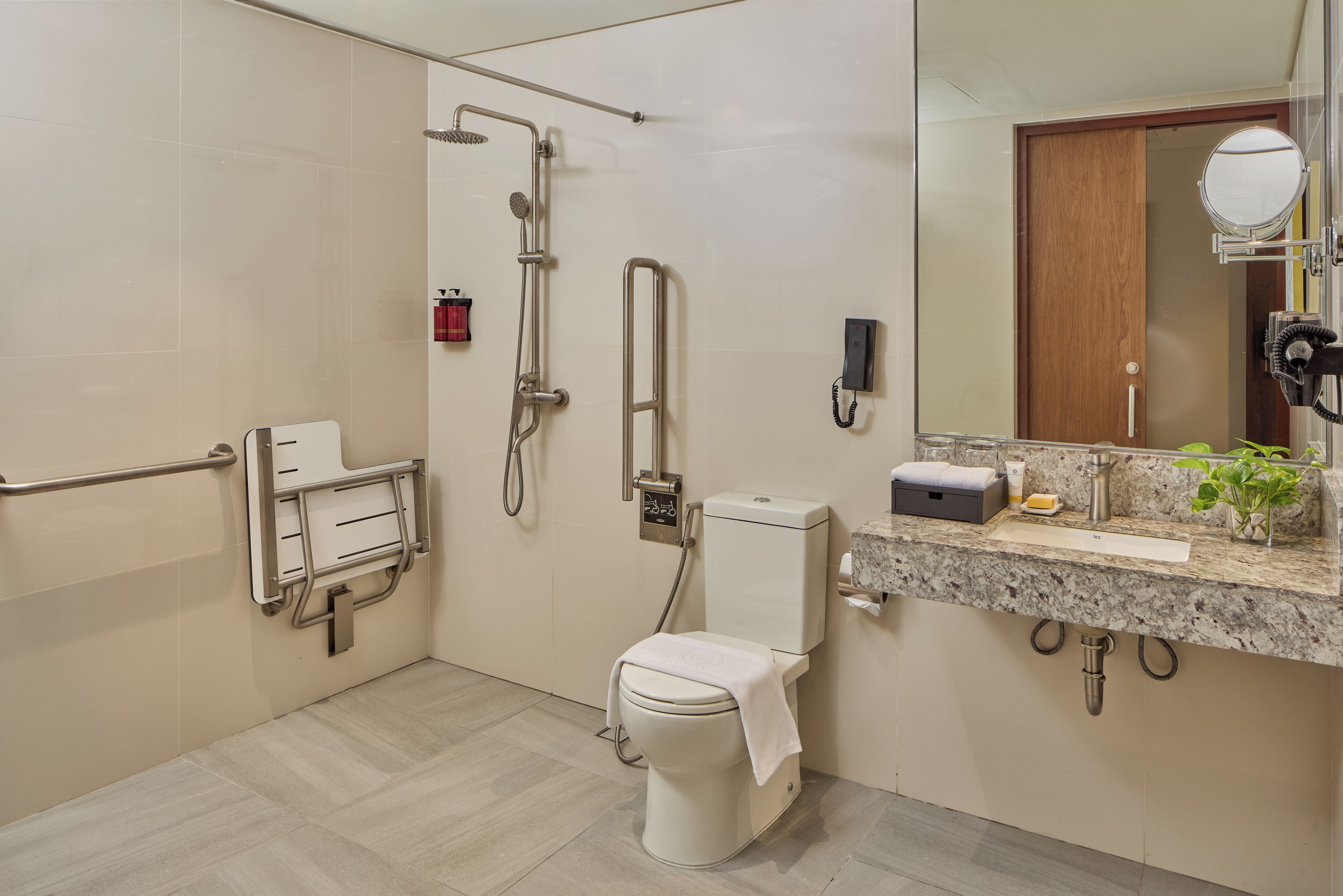 A modern bathroom with a toilet, shower, and sink.