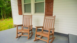 Two wooden rocking chairs on a porch with white siding and wooden shutters. -  Cozy country home with a beautiful creek at the back of the property.  (Mulberry)
