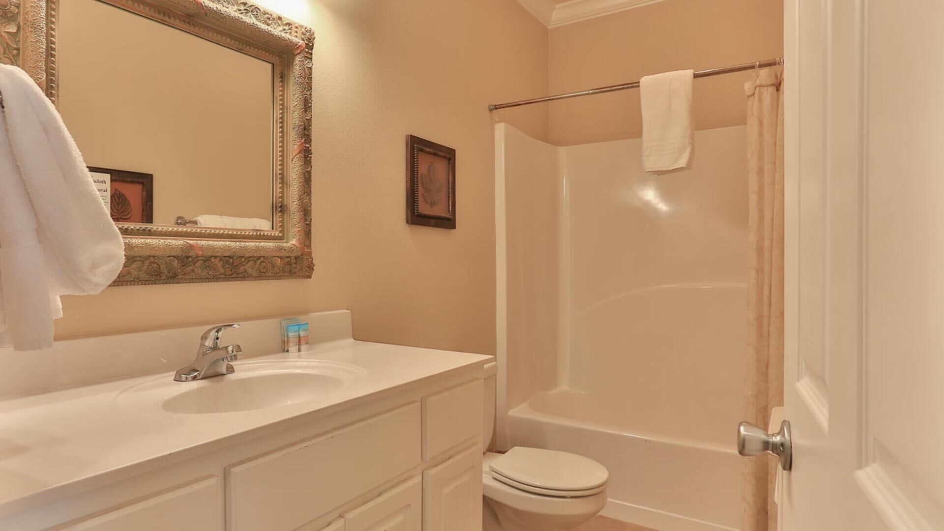 A bathroom with a sink, mirror, and toilet.