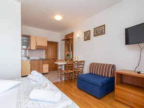 Relax in a stylishly designed room with a comfortable bed, sofa, and kitchenette.