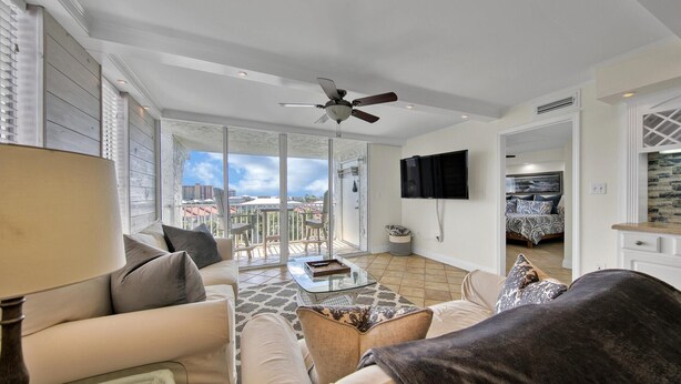 A spacious living room with a sofa, coffee table, and a ceiling fan. - Dolphin Point 502b (Destin)