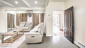 A modern living room with a sofa, a recliner, and a coffee table.