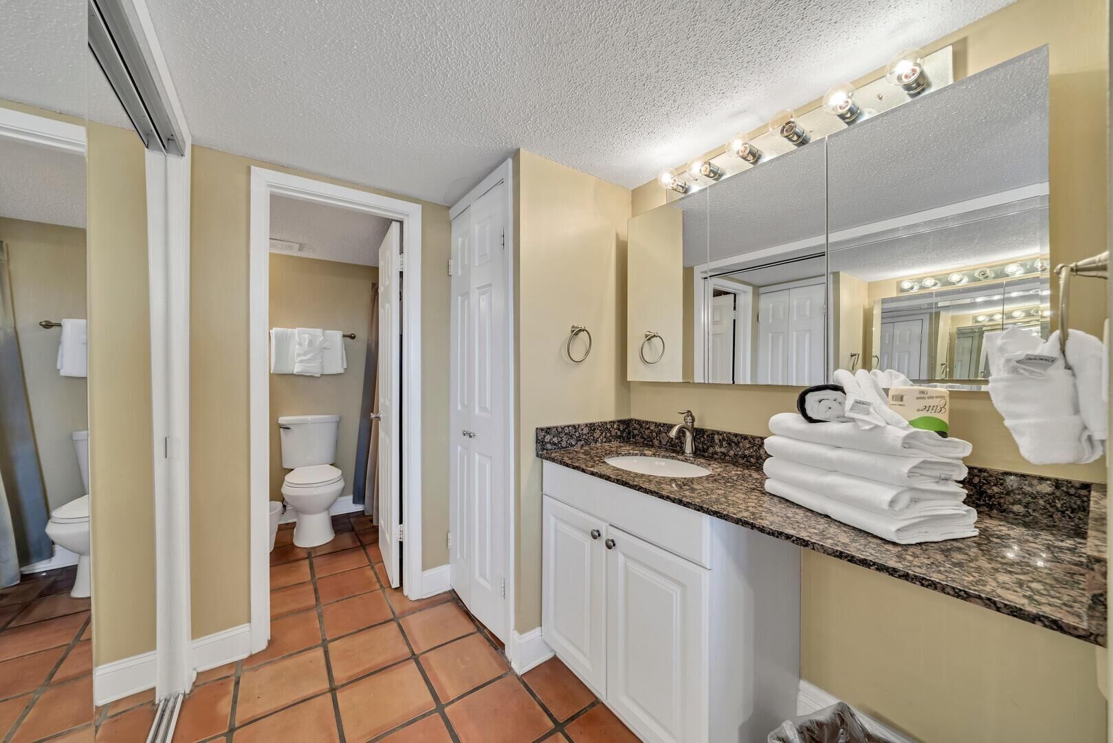A bathroom with a sink, mirror, and towel rack.