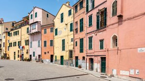 A row of colorful buildings with a clear street in front.