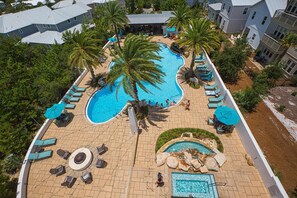 A resort with a large central pool, smaller pools, and a circular seating area.