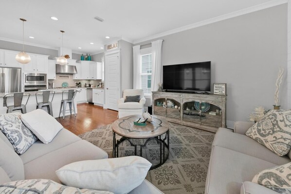 A modern living room with a sofa, coffee table, and a television.