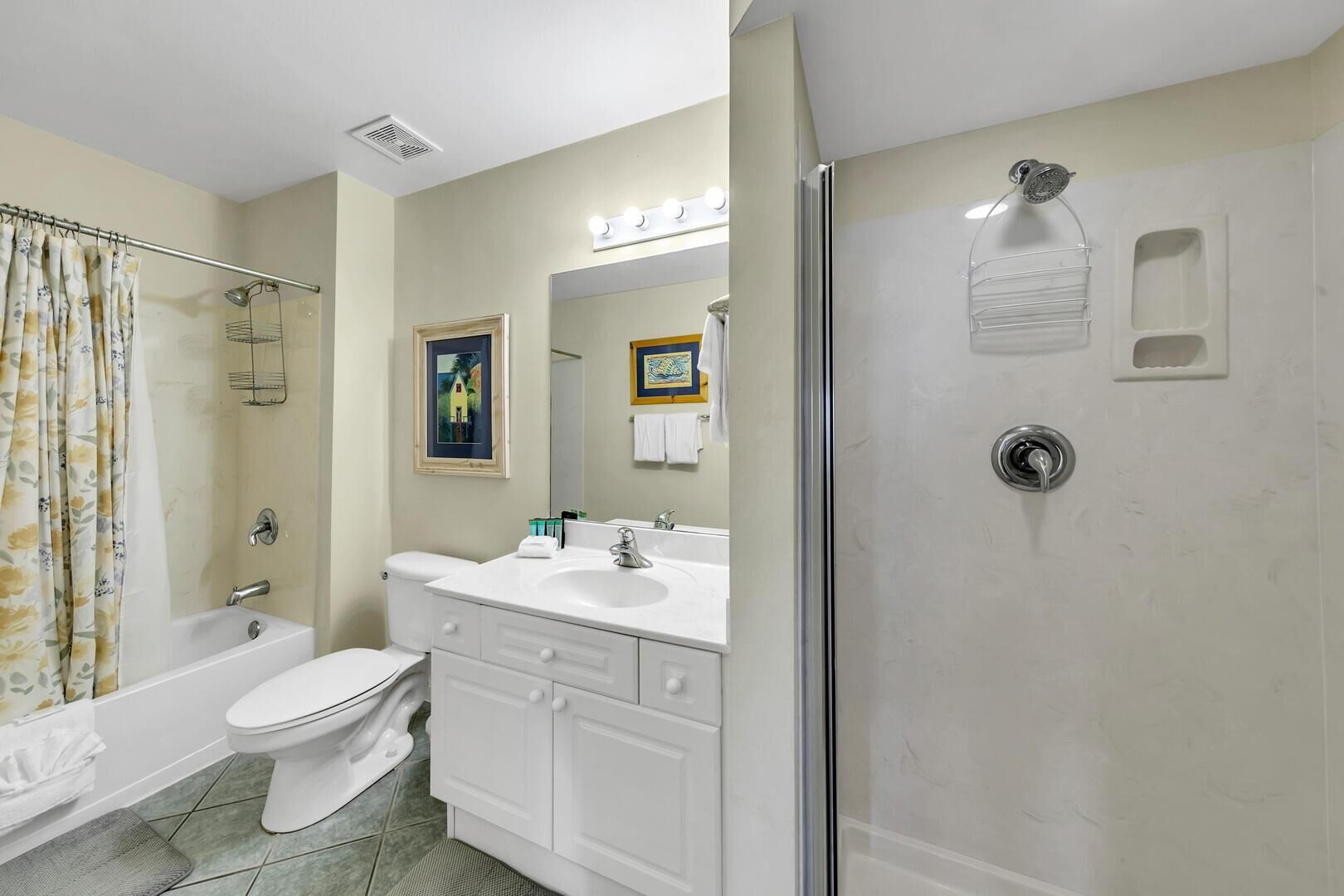 A bathroom with a toilet, sink, and shower.