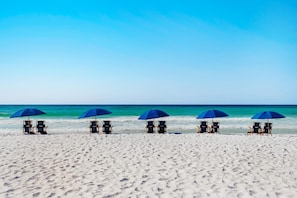 A beach with five rows of beach chairs and umbrellas, facing the ocean. - Silver Beach Towers - Penthouse106e (Destin)
