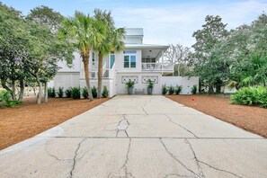 A two-story house with a front porch, a garage, and a driveway. - Cloud Nine (Santa Rosa Beach)