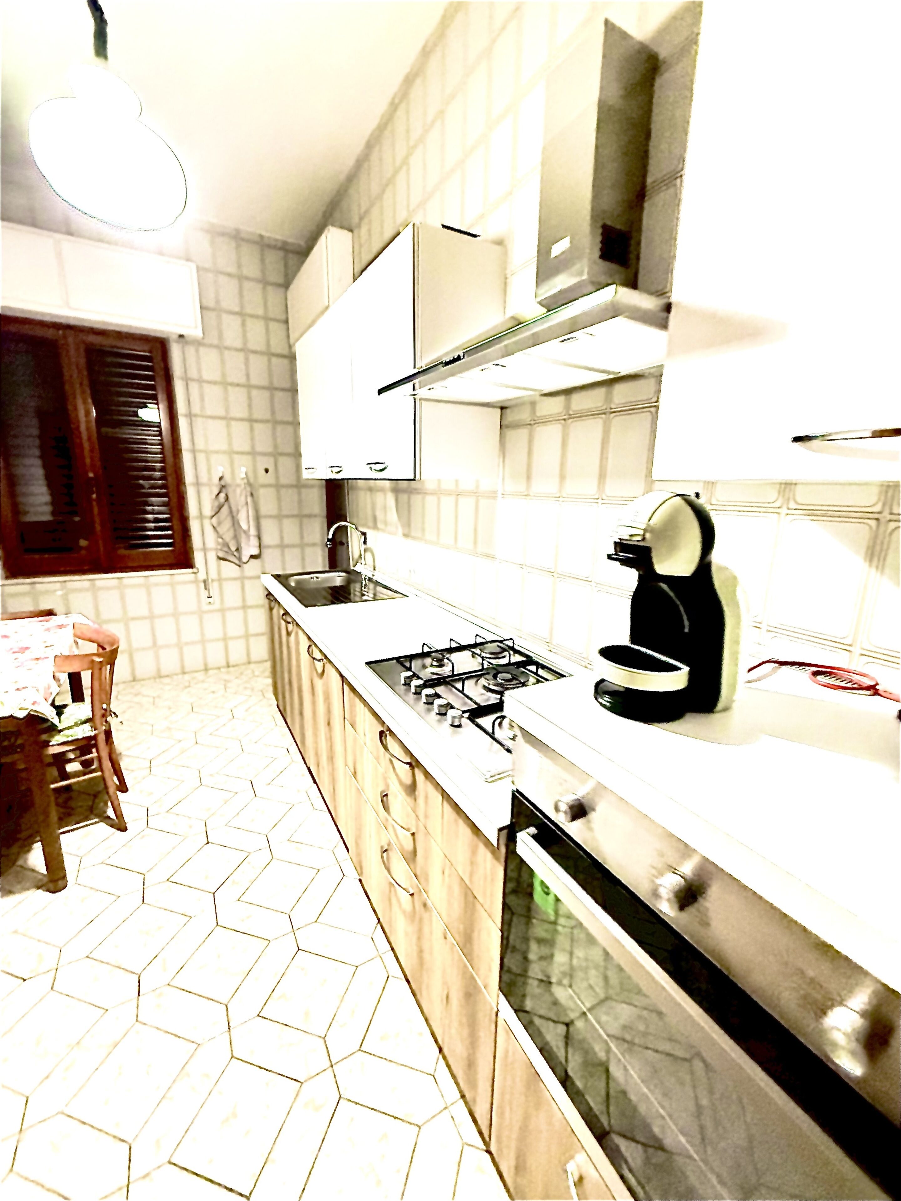 A kitchen with a gas stove, oven, and cabinets.