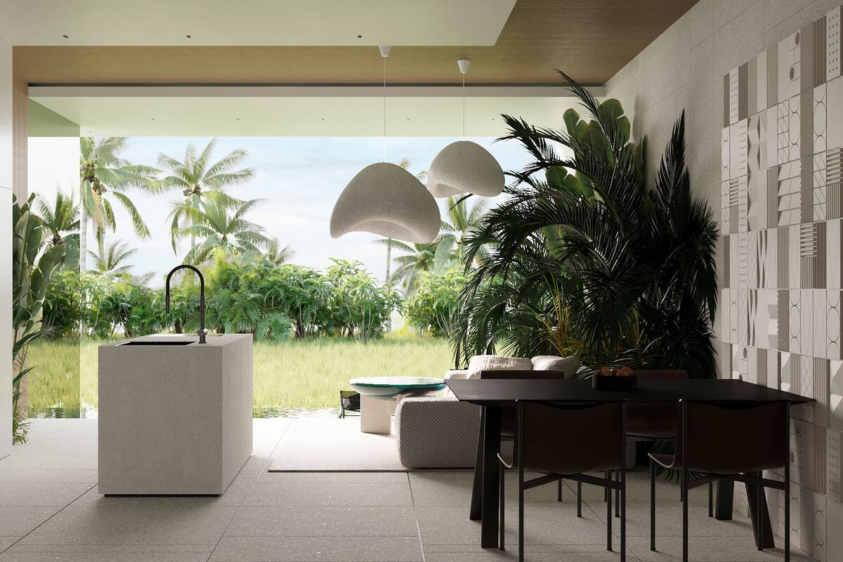 A modern interior with a minimalist design, featuring a central island with a sink, a dining area with a table and chairs, and a view of a tropical garden with palm trees.