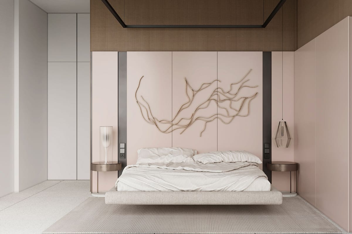 A modern bedroom with a minimalist design, featuring a bed with a white headboard, a wall-mounted abstract art piece, and two bedside tables with lamps.