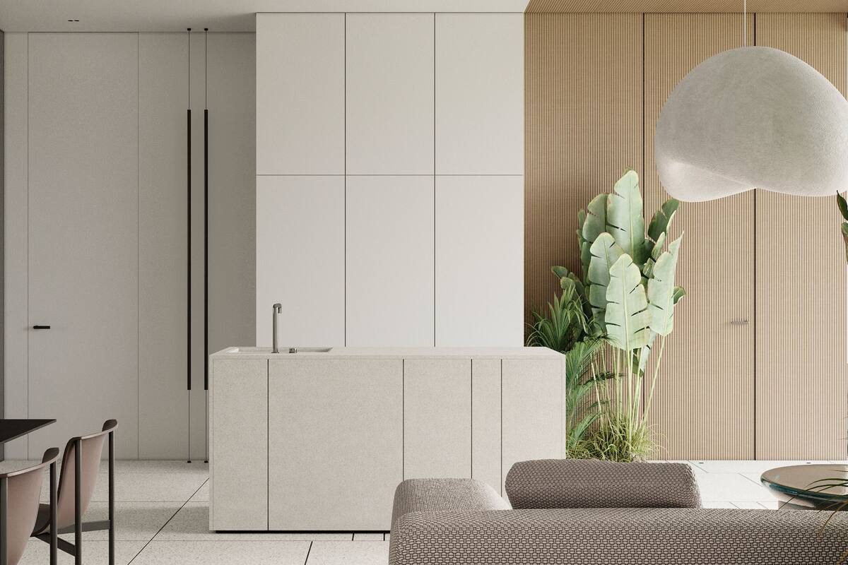 A modern kitchen with a central island, a dining area with a table and chairs, and a large plant.
