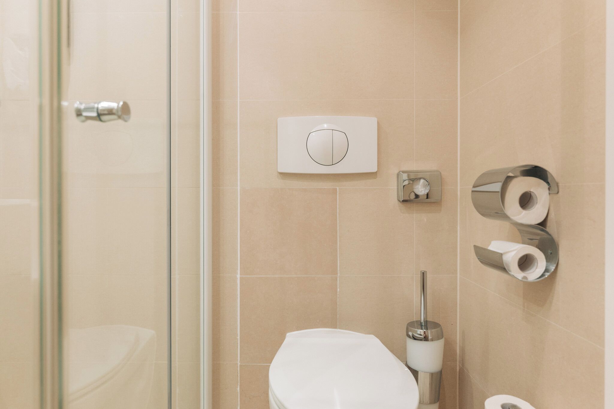 A bathroom with a toilet, a bidet, and a shower area.