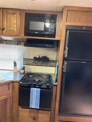 Fridge, microwave, stovetop, coffee/tea maker