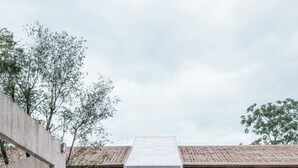 A modern building with a central courtyard and reflective water surface. - qingyuansanhedaoli (Qingyuan)