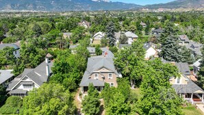 A residential area with houses surrounded by trees and mountains in the background. - Noble Summit BBQ & Fire Pit  & Scenic Views (Colorado Springs)