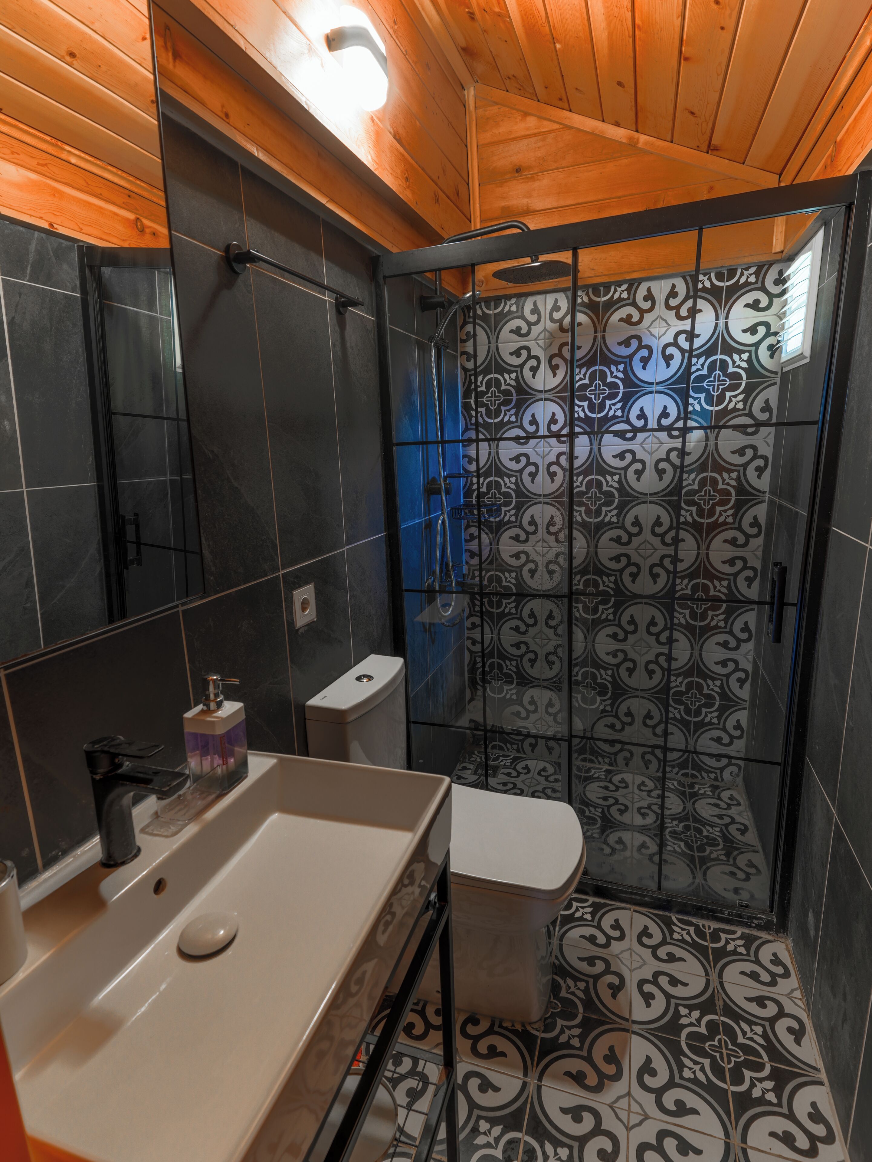 A bathroom with a shower, toilet, and sink.