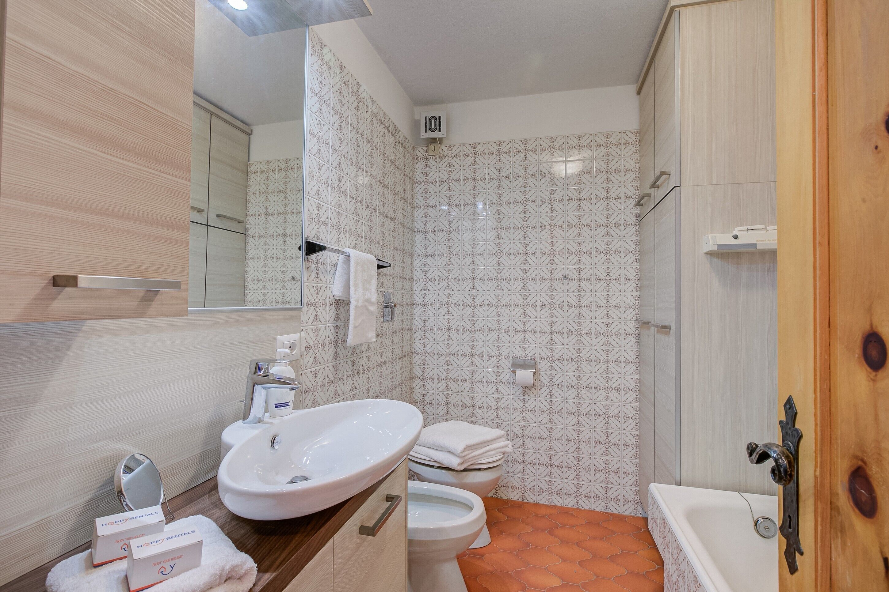 A bathroom with a sink, toilet, and bathtub.