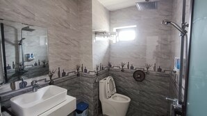 Un baño con lavamanos, inodoro y ducha.