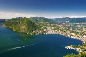 A coastal town with a mountain, a marina, and a large body of water.
