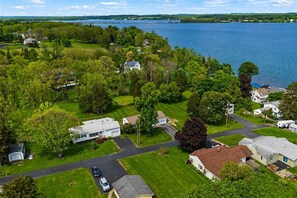 A residential area with houses, a road, and a lake. - Lake Views | Cayuga Wine Trail | Hot Tub | FLX (Seneca Falls)