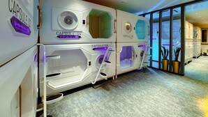 A row of capsule-style hotel rooms with a modern design, each labeled with a capsule number. - UBPOD capsule hotel in Mongolia (Ulaanbaatar)