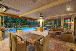 An outdoor patio area with a pool, wicker furniture, and a ceiling fan. - Santa Ynez Vineyard Retreat | Pool & Spa (Santa Ynez)