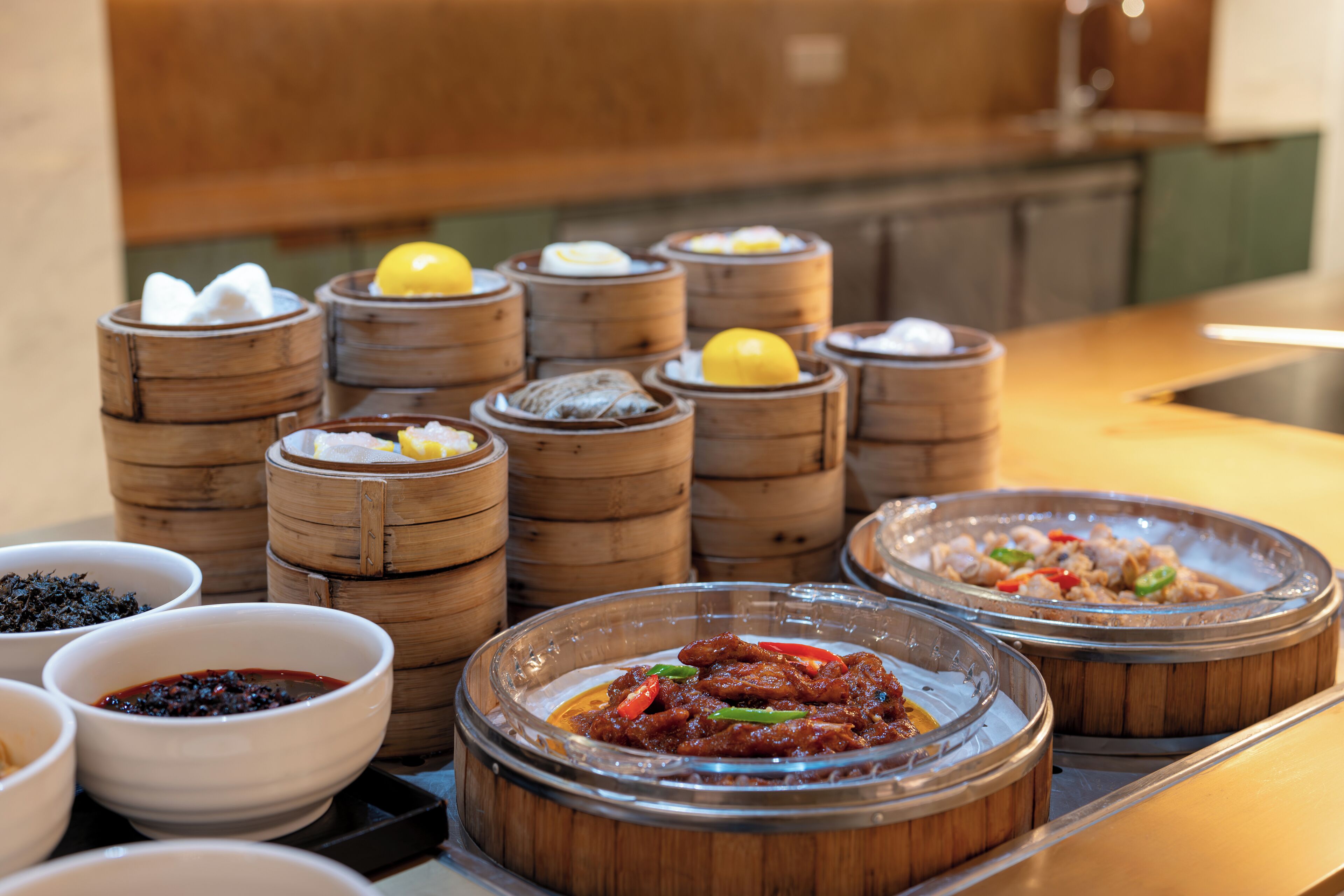 A variety of food items, including dim sum and other dishes, arranged on a tray.