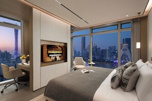 A modern hotel room with a large bed, a desk, and a TV. The room has a city view through large windows. - Ascott Pazhou Guangzhou (Guangzhou)