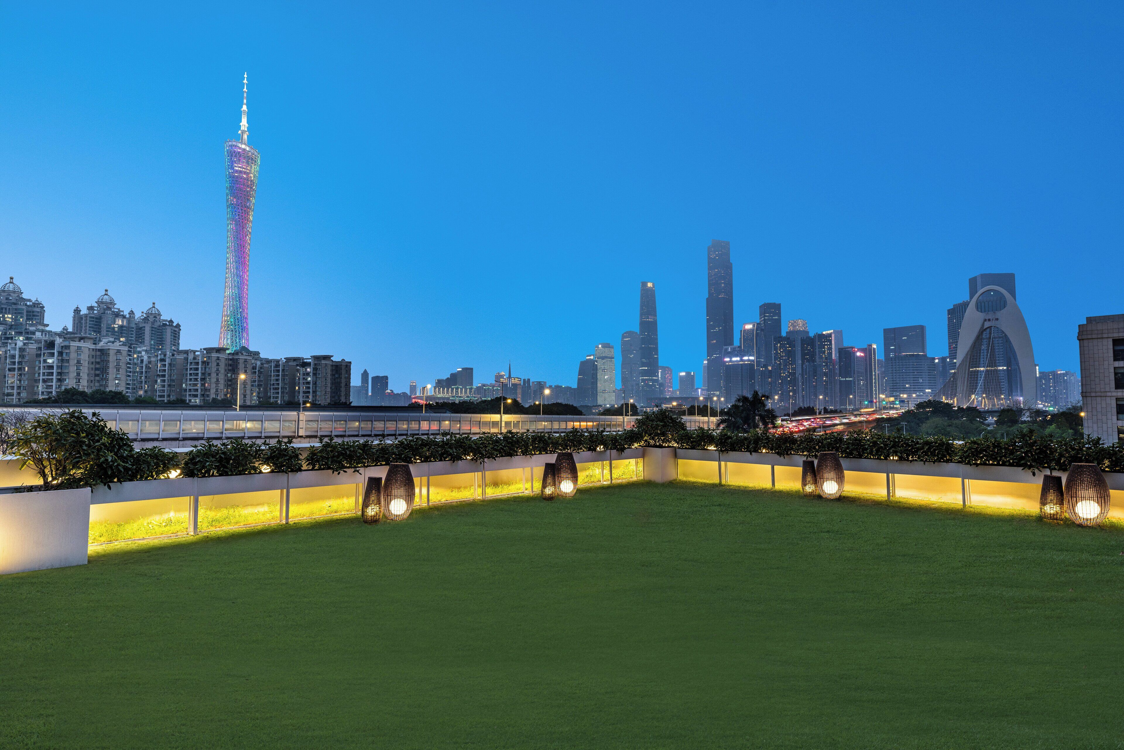 A city skyline with a prominent tower and modern buildings.
