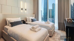 A modern hotel room with two beds, a large window with a city view, and a minimalist decor. - WelHome - Exclusive 2BR Apartment in Downtown Forte (Dubai)