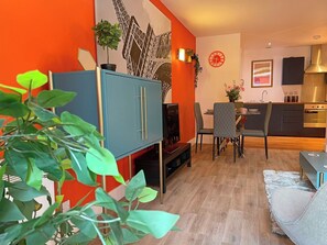 Relax in a cozy living area with a comfortable seating arrangement and dining area nearby.