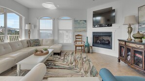 A living room with a sofa, coffee table, and a fireplace. - 5 Minutes to Beach - Large Complex Pool (Santa Rosa Beach)