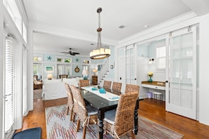 A dining area with a table, chairs, and a chandelier. - Watercolor - Watercolor Amenity Passes - Sleeps 8 (Santa Rosa Beach)