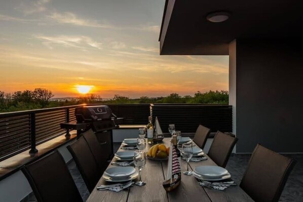 Enjoy a meal with a scenic view of the surrounding landscape and water from this outdoor dining area.