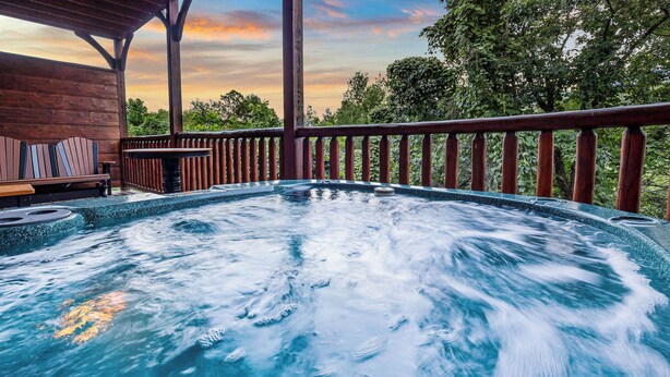A hot tub area with a wooden deck and a view of trees. - Views, Hot Tub, Fireplace, Resort Pool, + Game Room (Gatlinburg)