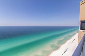 A clear view of a beach with turquoise waters and a white sandy shore.