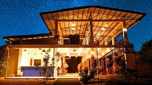 A modern building with a large open space, a staircase, and a balcony. - AmanDagat Beach Resort (San Felipe)