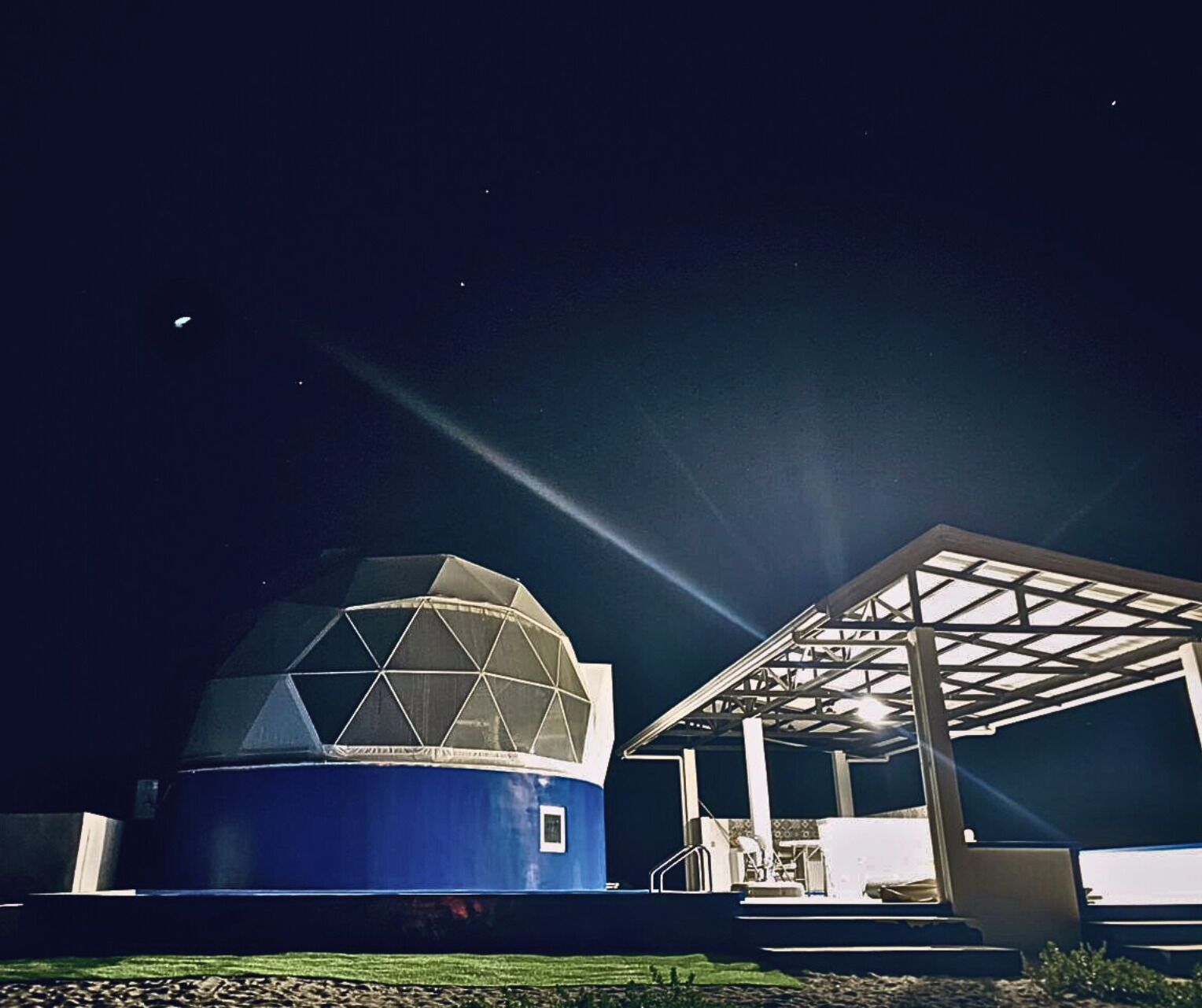 A large observatory with a dome structure and a covered pavilion.