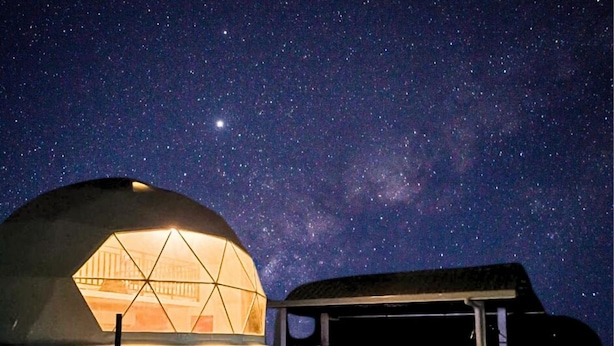 A dome-shaped structure with a pool and lounge area under a starry night sky. - AmanDagat Beach Resort (San Felipe)