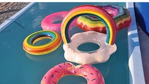 A pool with inflatable rings and a donut-shaped ring. - AmanDagat Beach Resort (San Felipe)