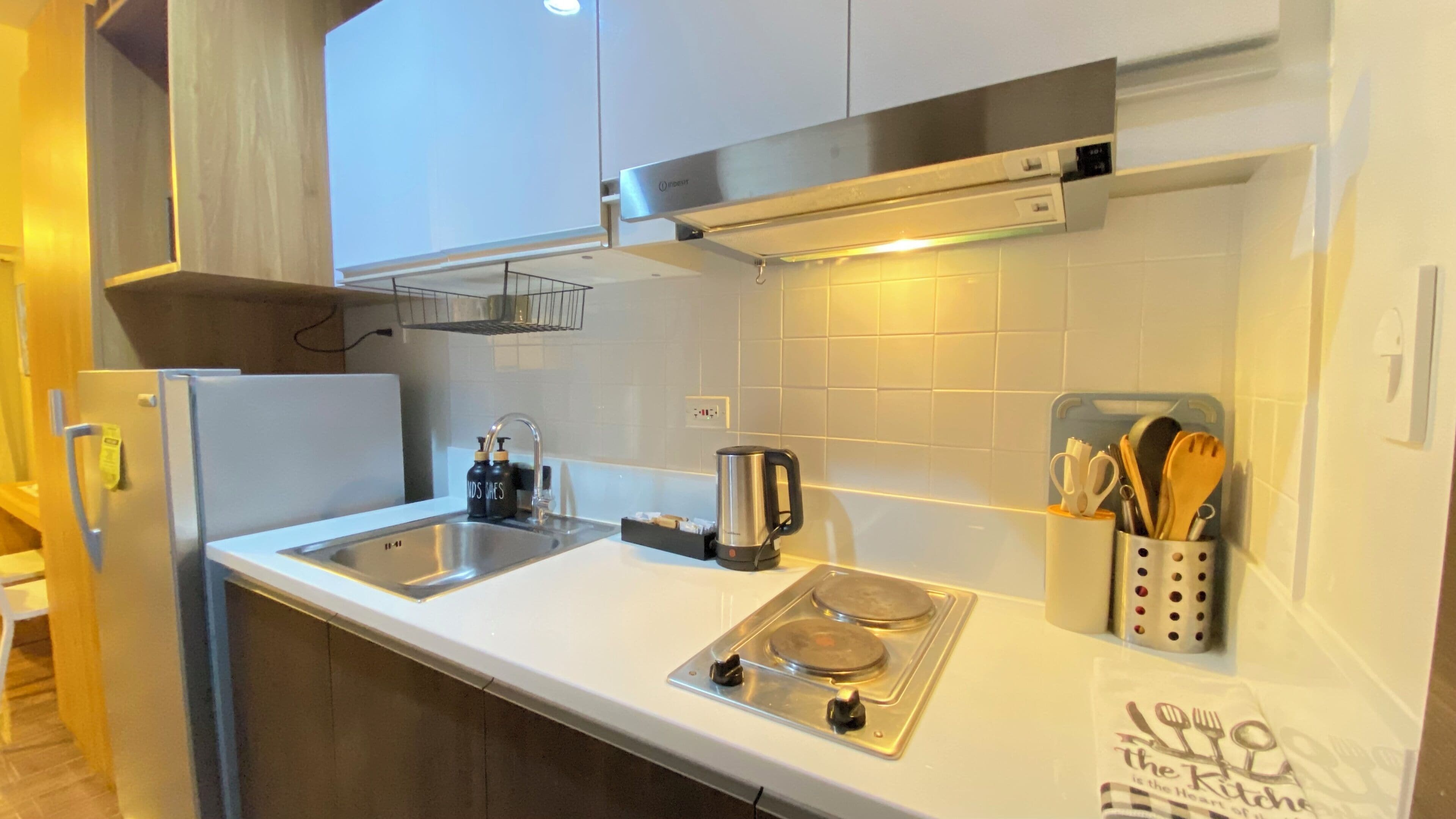 A modern kitchen with stainless steel appliances, a double sink, and a gas stove.