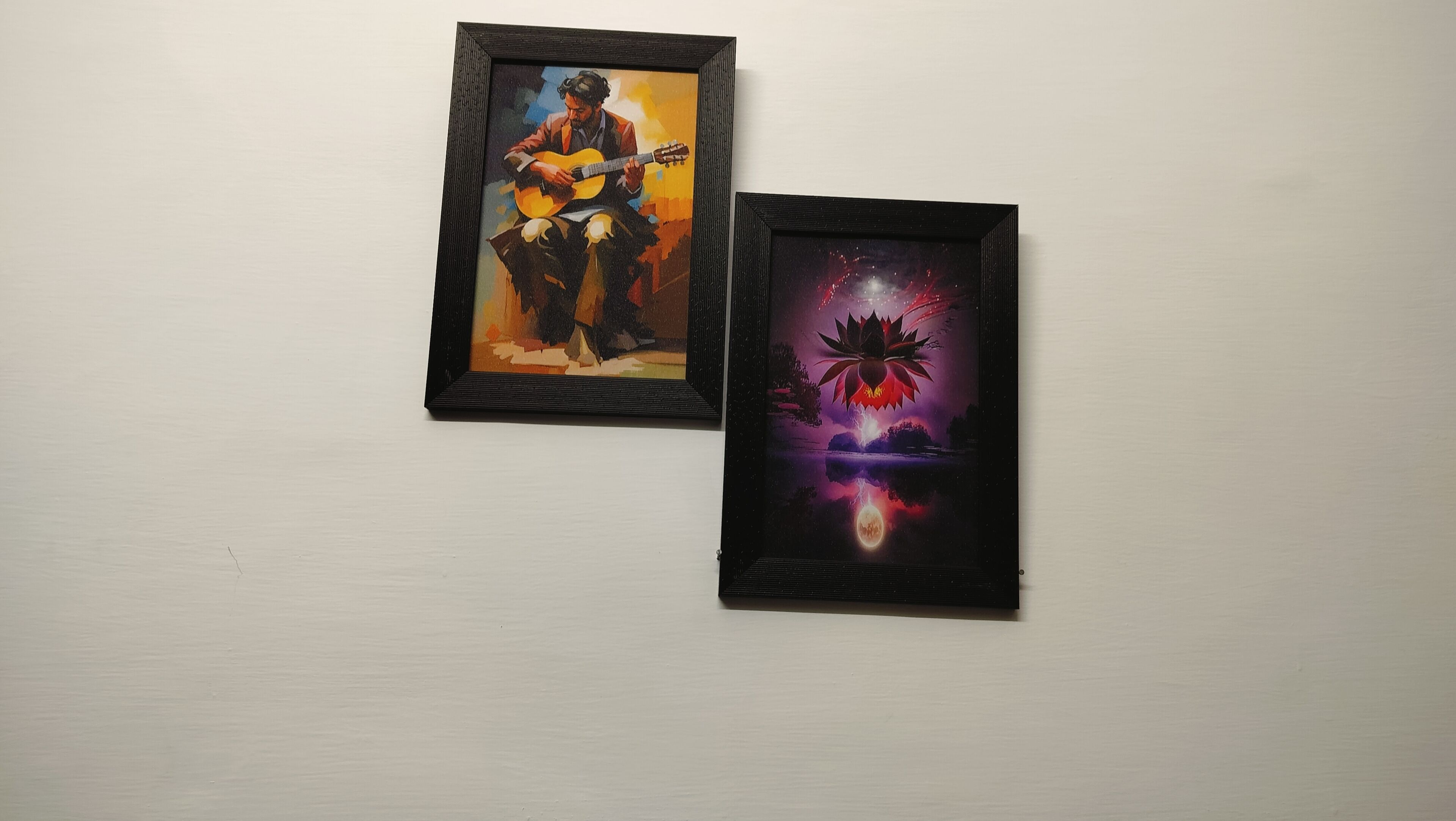 Two framed artworks on a wall.