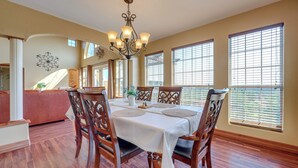 A dining area with a table set for four, surrounded by wooden chairs. - Family-friendly Fischer Home w/ Private Hot Tub! (Canyon Lake)