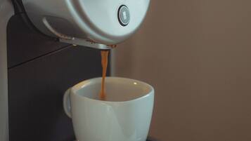 A coffee machine dispensing espresso into a cup.