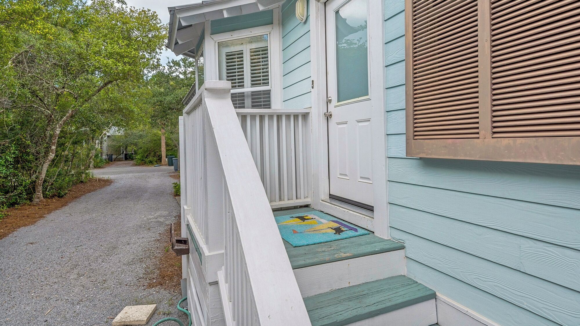 A house with a porch, a door, and a window.