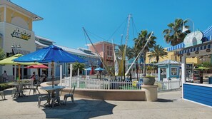 A sunny outdoor area with a fenced playground, a blue umbrella, and a Subway restaurant in the background. - Close to Beach Access & Rosemary~ Seacrest Lagoon Pool Access (Panama City Beach)